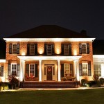 front of large home lighting porch